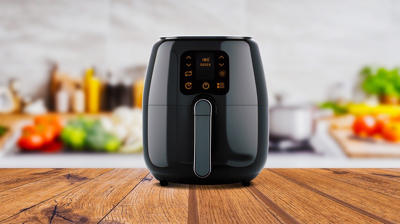 An air fryer on a wooden surface