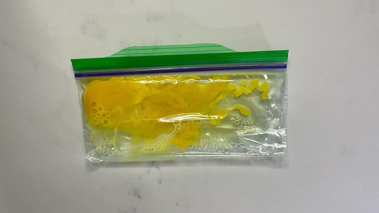 Scrambled raw egg in ziplock bag