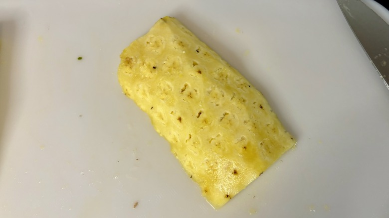 Pineapple hunk on cutting board