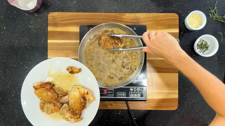 Adding chicken to the pan