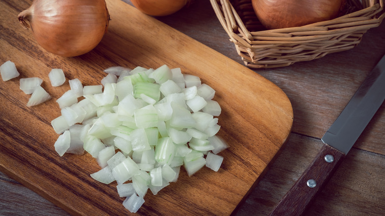 diced onion on cutting board with knife