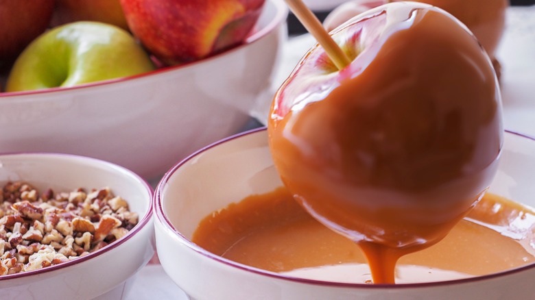 Dipping a caramel apple