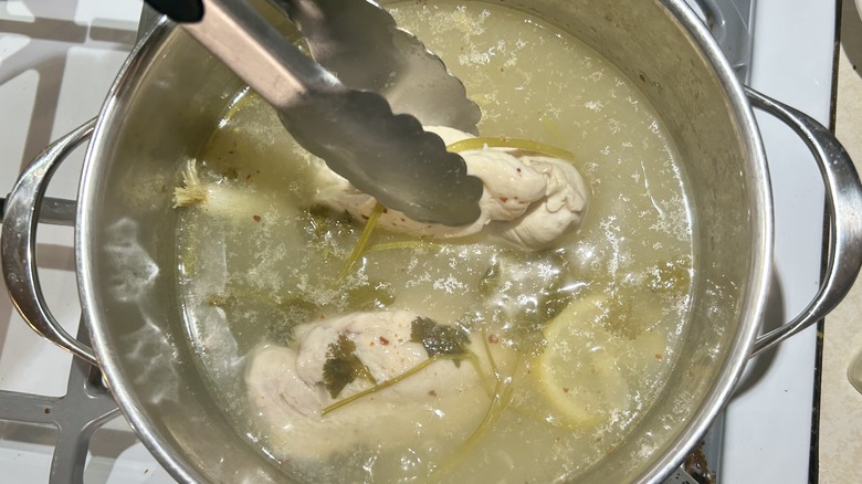 chicken breasts in simmering pot