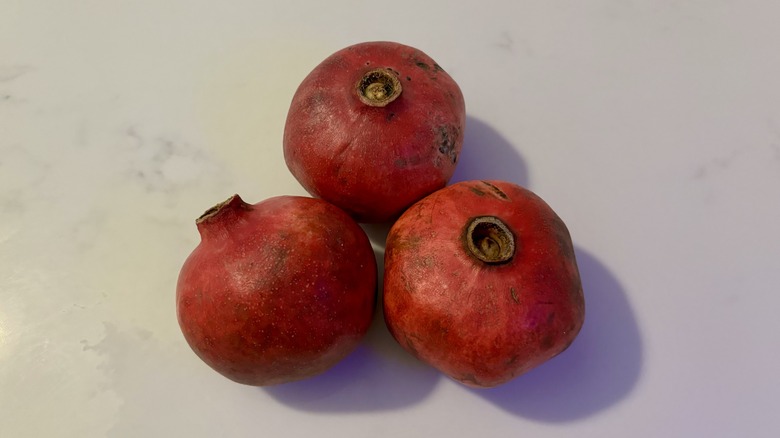 Three over-ripe pomegranates 