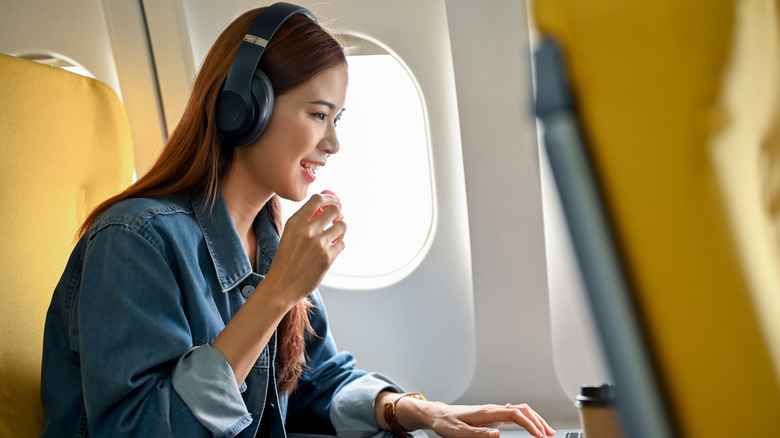 person eating snacks on plane