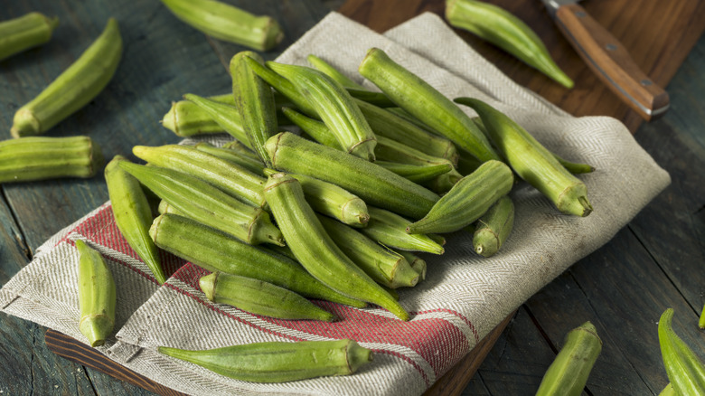 Pile of okra on a cloth napkin on a table