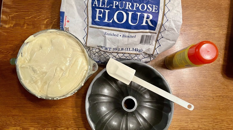 Cake batter, pan, flour, oil, and spatula