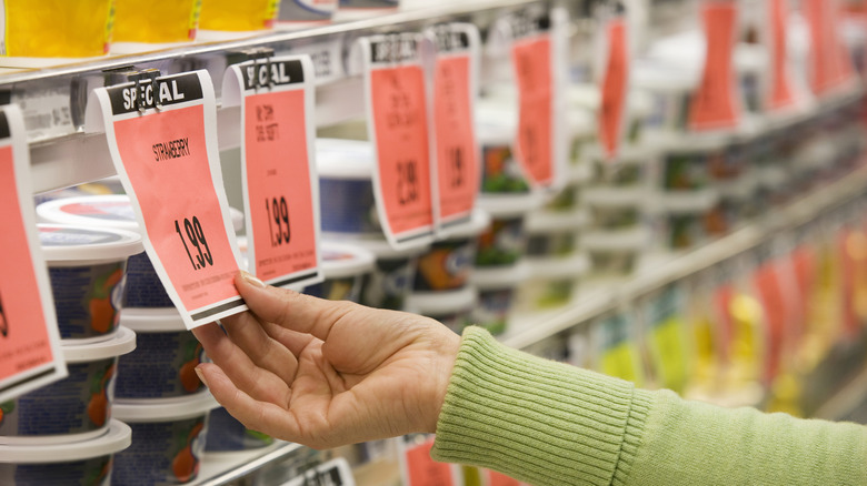 a person looks at a row of sales in a grocery store