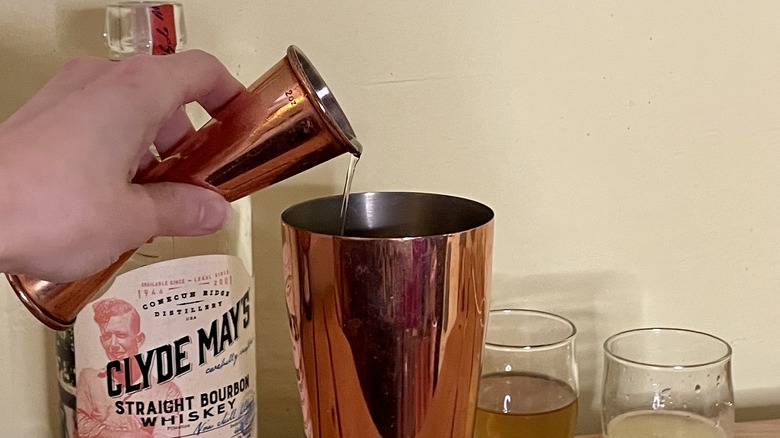 Bourbon poured into cocktail shaker