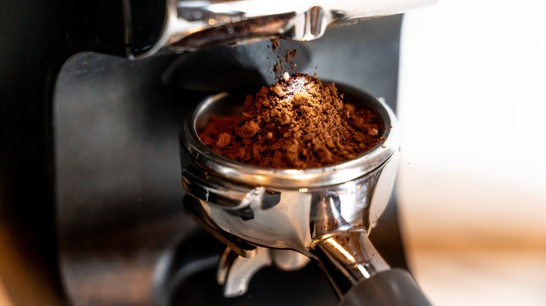 coffee grounds falling into portafilter