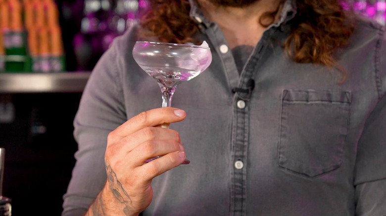 Swirling ice in martini glass