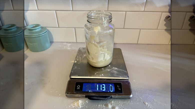 A jar on scale weighing 113 grams