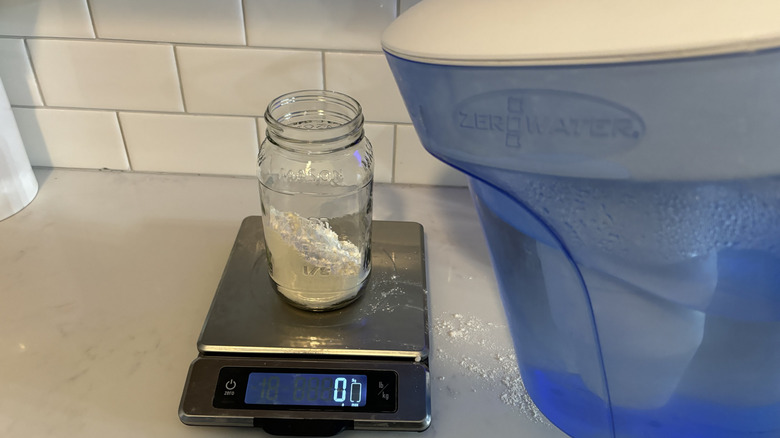 Water poured into a jar with flour