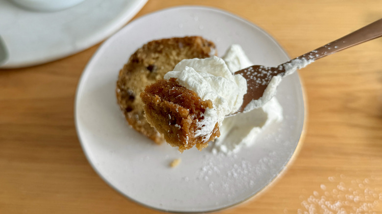 Spoonful of whiskey cake with whipped cream