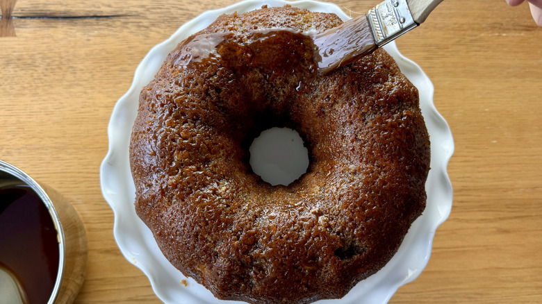 Brushing Bundt cake with glaze
