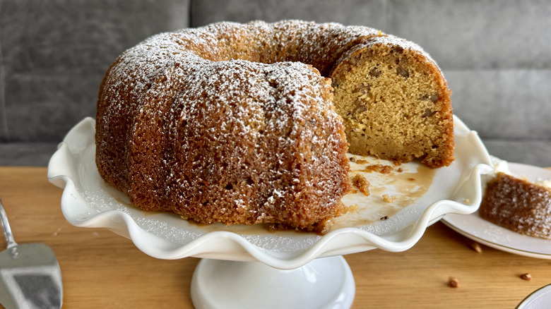 Bundt cake on stand with slice removed
