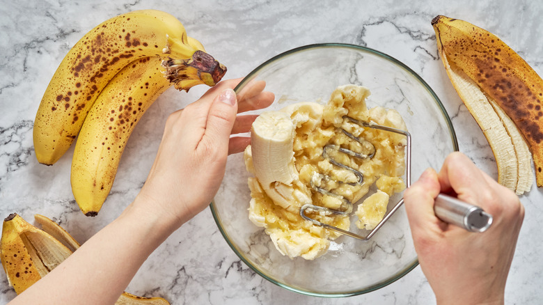 Mashing banana in bowl