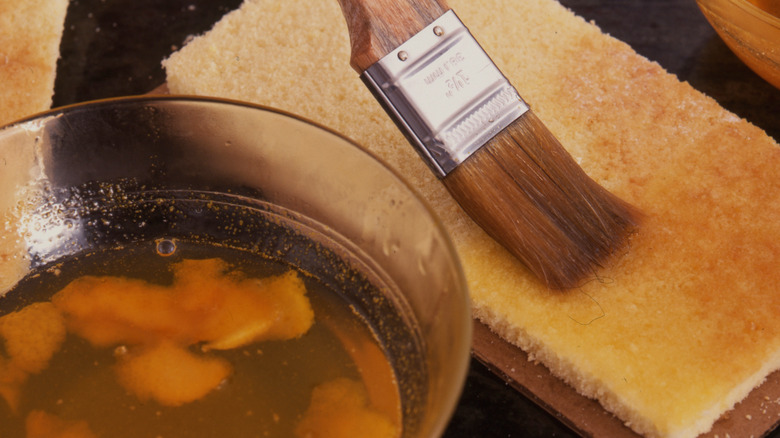 Brushing cake with syrup