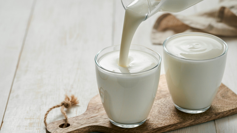 Pouring buttermilk into glasses