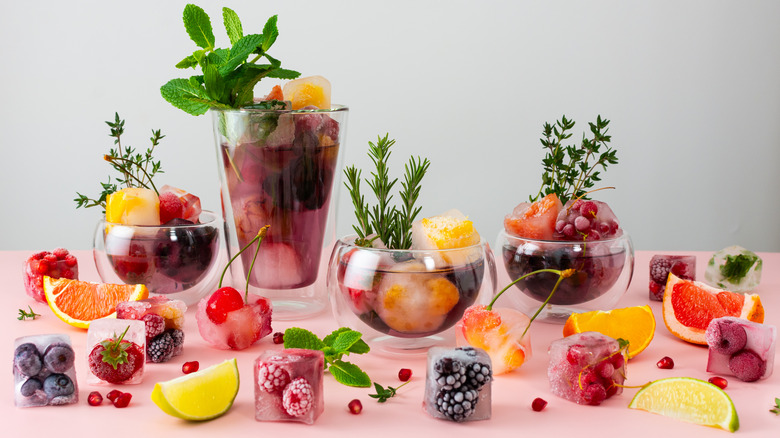 Frozen fruit ice cubes in and out of cocktails