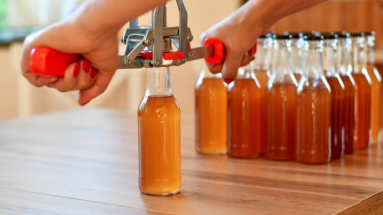 Person capping bottles of mead