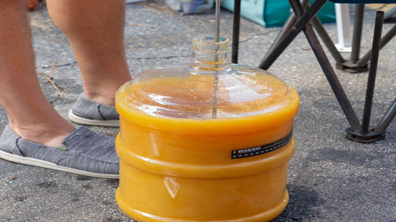 Honey being mixed into water for mead