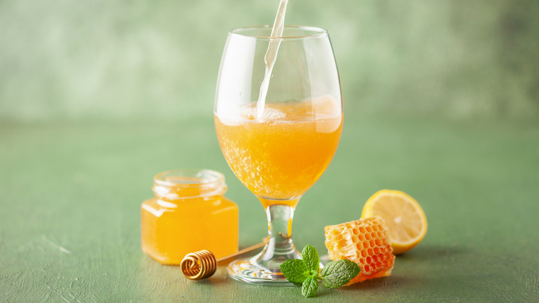 Glass of mead with honeycomb pieces