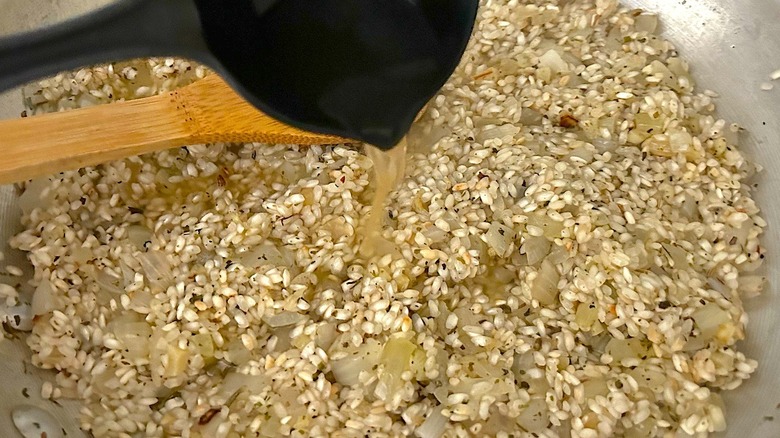 Adding stock to risotto