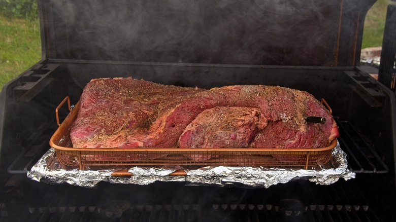 A brisket on the smoker getting ready to be cooked