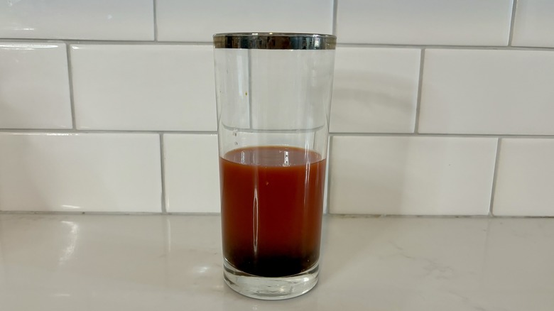 Tomato juice and ingredients in cup