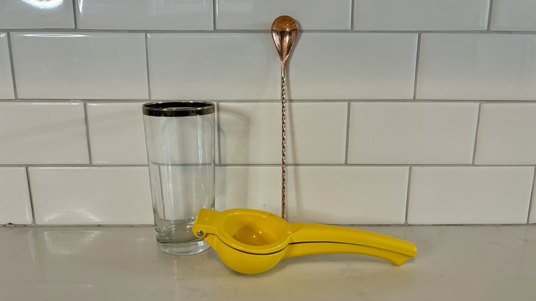 Collins glass, lemon juicer, spoon