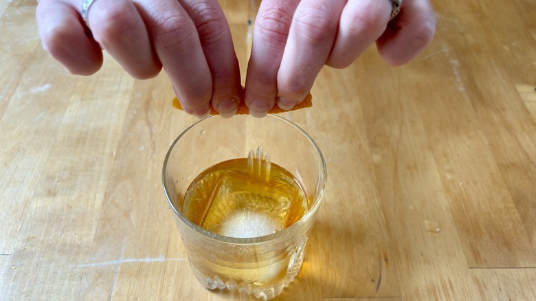 Hand pinching orange peel