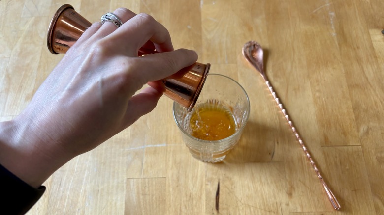 Whiskey poured into cup