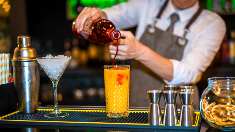 Bartender making a sex on the beach cocktail