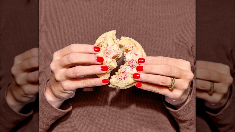 Hands break apart a cookie