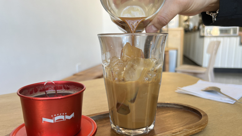 Pouring coffee over ice