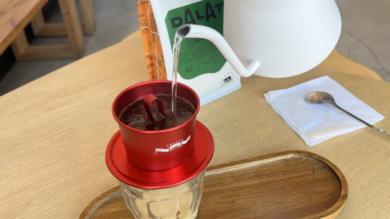 Pouring hot water from kettle