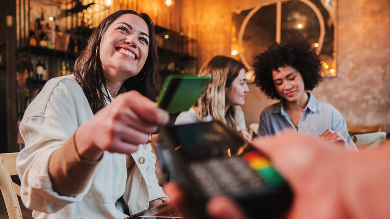 Smiling customer paying bill