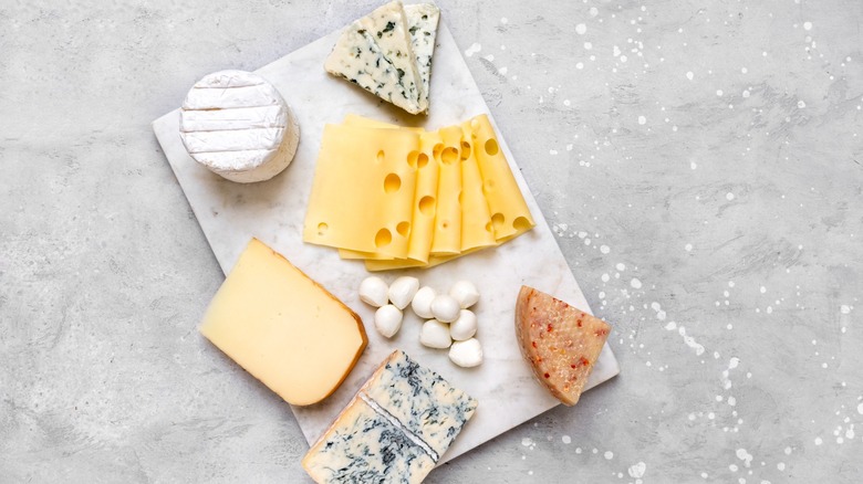 A cheese platter with a variety of cheeses