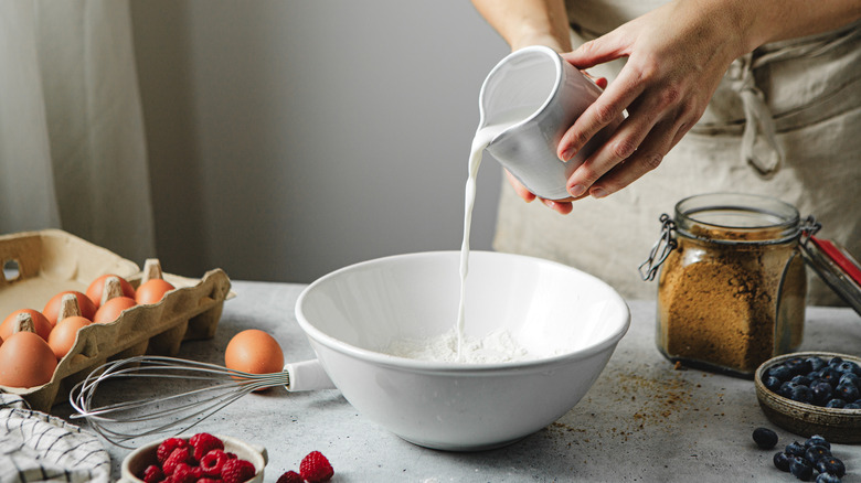 Pouring milk into baking ingredients