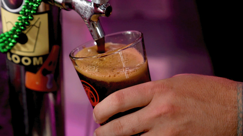 Pouring draft beer into a pint glass