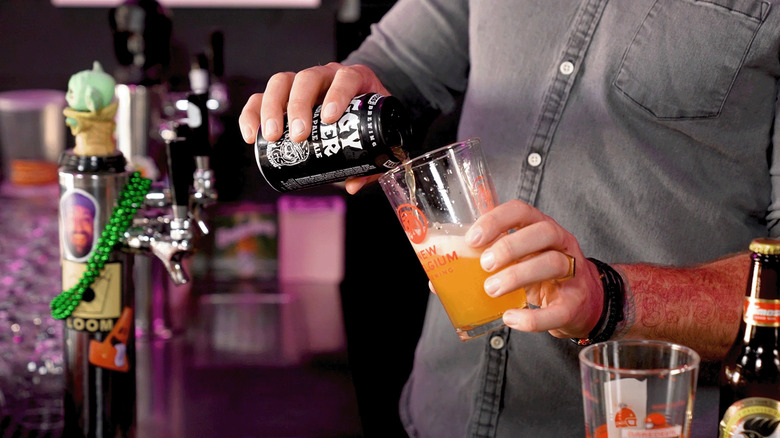 Pouring beer from a can into a pint glass