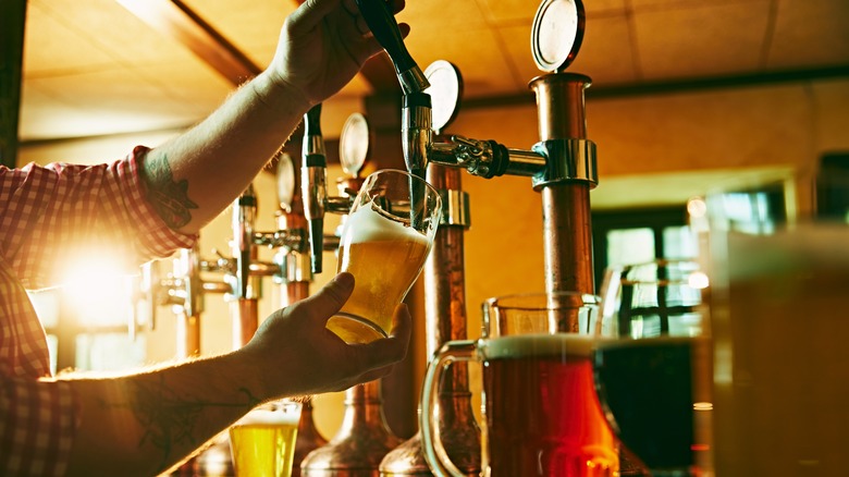 bartender pouring beer from tap