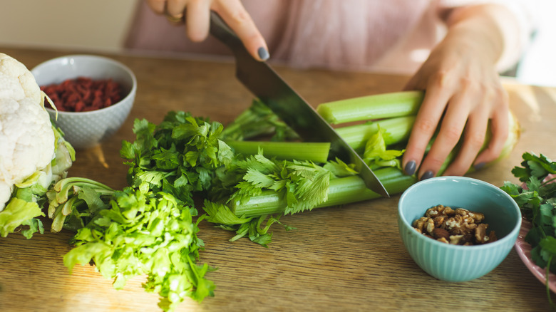 a person chipping stalks of celery