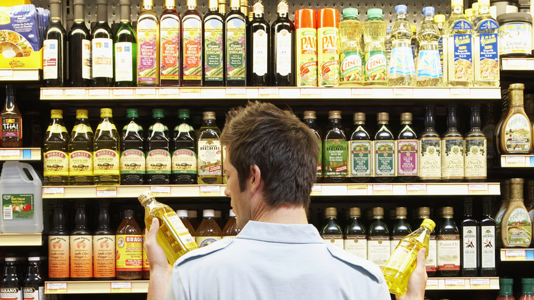 Man confused by oils at grocery store