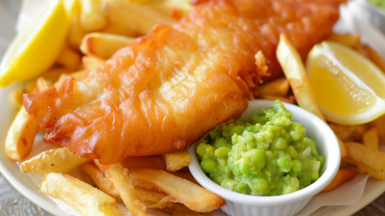 Fish and chips served with lemon and mushy peas