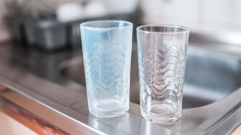 cloudy and clear glasses on sink