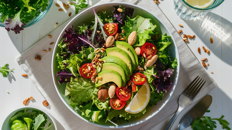 Salad with leafy greens, avocado, and tomatoes