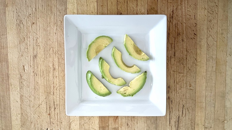Slices of avocado on plate