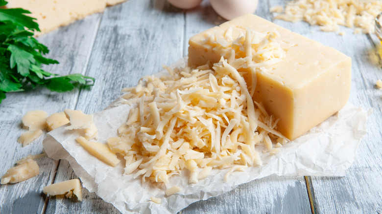 Grated block of cheese on paper